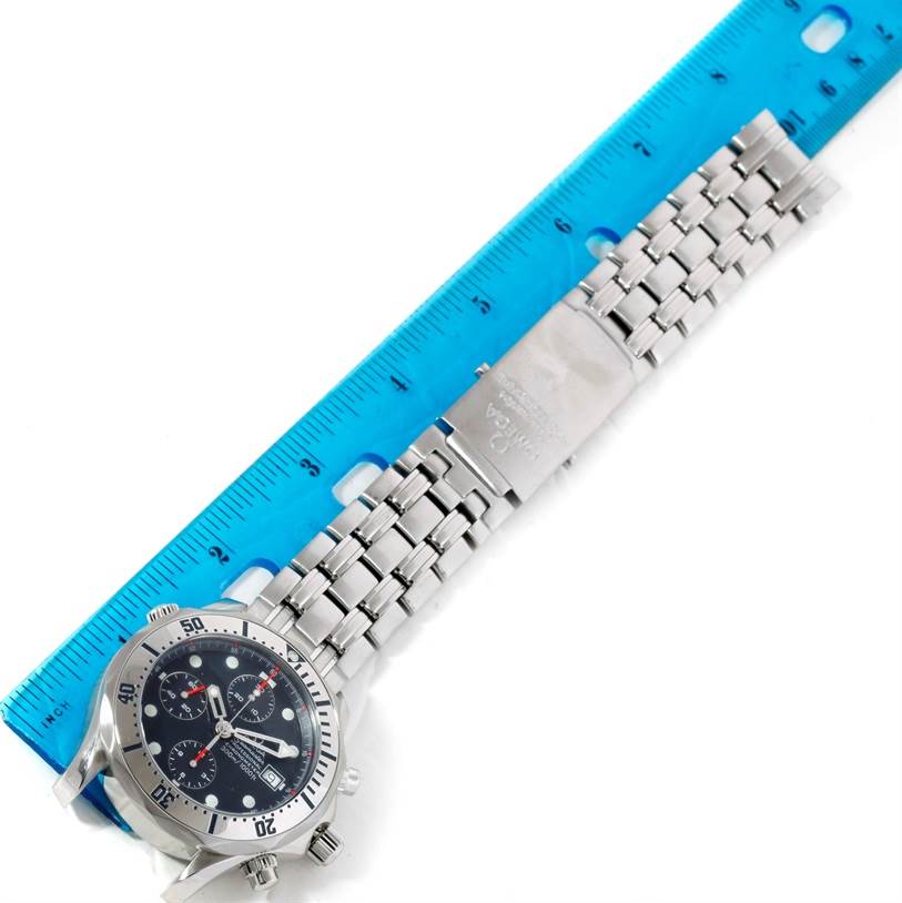 The Omega Seamaster 2598.80.00 Men
s Stainless Steel Blue Dial 2598.80.00 Men
s Stainless Steel Blue Dial watch is displayed horizontally, showing the dial, bezel, and full metal bracelet against a blue ruler.