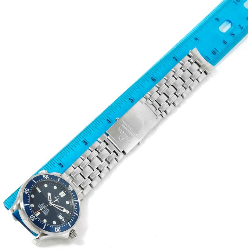 The image shows the Omega Seamaster 2531.80.00 Men
s Stainless Steel Blue Dial 2531.80.00 Men
s Stainless Steel Blue Dial watch laid flat with a ruler alongside, showing the face, bracelet, and clasp.