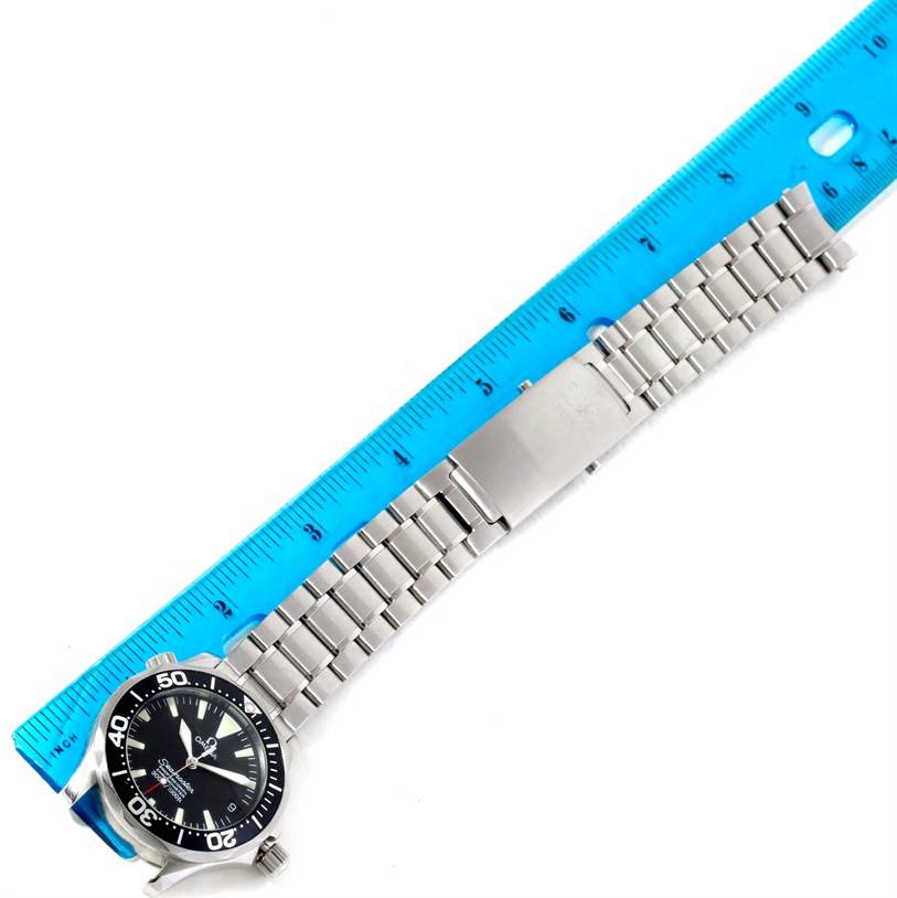 The Omega Seamaster 2252.50.00 Stainless Steel Black Dial 2252.50.00 Stainless Steel Black Dial watch is shown from a top-down angle, highlighting the face, bezel, and stainless steel bracelet next to a ruler.