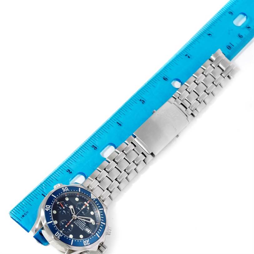 The image shows a partial view of the Omega Seamaster 2225.80.00 Men
s Stainless Steel Blue Dial 2225.80.00 Men
s Stainless Steel Blue Dial watch with the dial and metal strap, measured against a blue ruler.