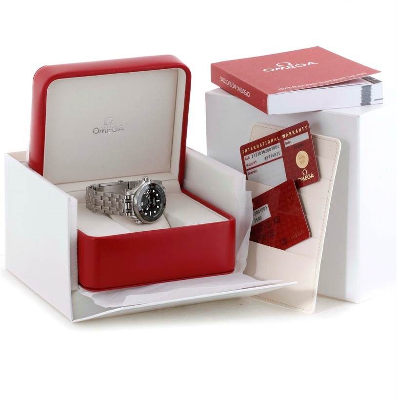 The image shows an Omega Seamaster 212.30.36.20.01.002 Men
s Stainless Steel Black Dial 212.30.36.20.01.002 Men
s Stainless Steel Black Dial watch in its open red box along with warranty cards and a user manual.