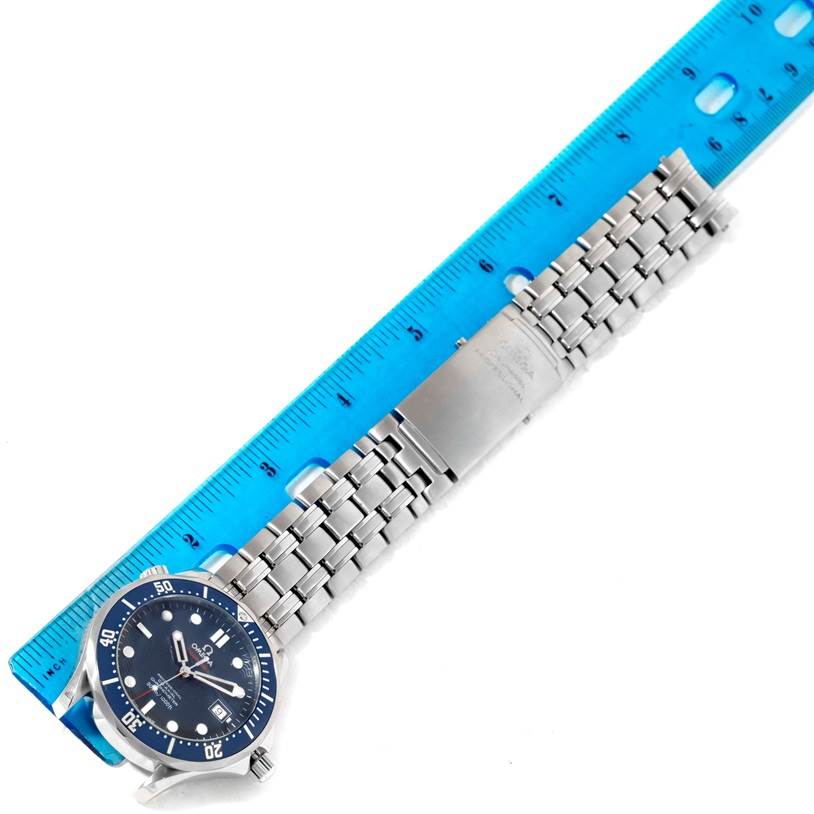 The image shows an Omega Seamaster 2220.80.00 Men
s Stainless Steel Blue Dial 2220.80.00 Men
s Stainless Steel Blue Dial watch with a blue dial and stainless steel bracelet, next to a blue ruler for size reference.