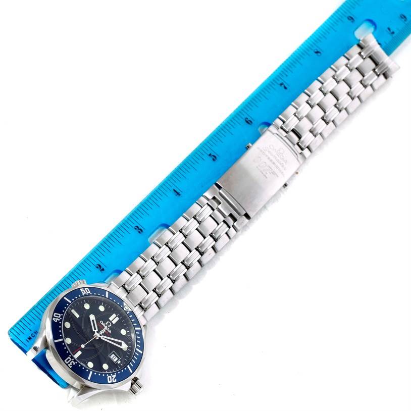 The image shows an Omega Seamaster 2226.80.00 Men
s Stainless Steel Blue Dial 2226.80.00 Men
s Stainless Steel Blue Dial watch, laid flat with its metal bracelet, accompanied by a blue ruler for scale.