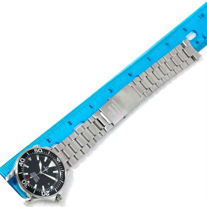 The Omega Seamaster 2254.50.00 Men
s Stainless Steel Black Dial 2254.50.00 Men
s Stainless Steel Black Dial watch is shown flat, displaying the face, full metal bracelet, and clasp alongside a ruler.