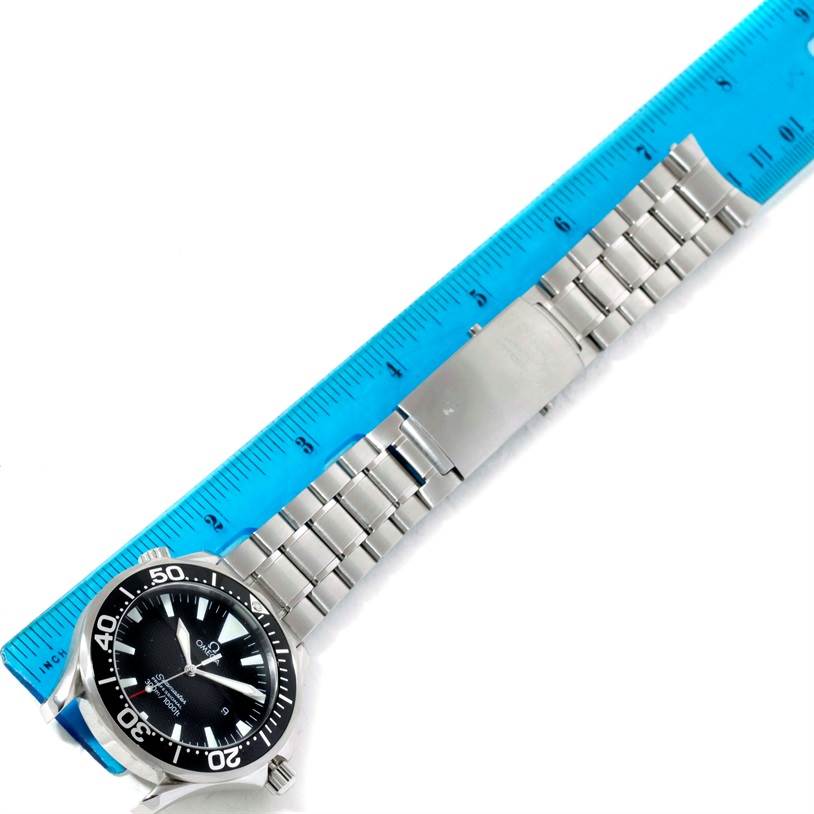 This image shows the Omega Seamaster 2264.50.00 Men's Stainless Steel Black Dial 2264.50.00 Men's Stainless Steel Black Dial watch face, bezel, and entire metal bracelet alongside a blue ruler.