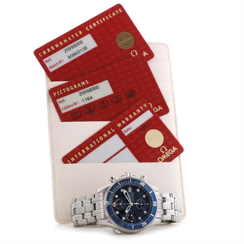 The image shows an Omega Seamaster 2599.80.00 Men
s Stainless Steel Blue Dial 2599.80.00 Men
s Stainless Steel Blue Dial watch with its chronometer certificate, pictograms, and international warranty cards.
