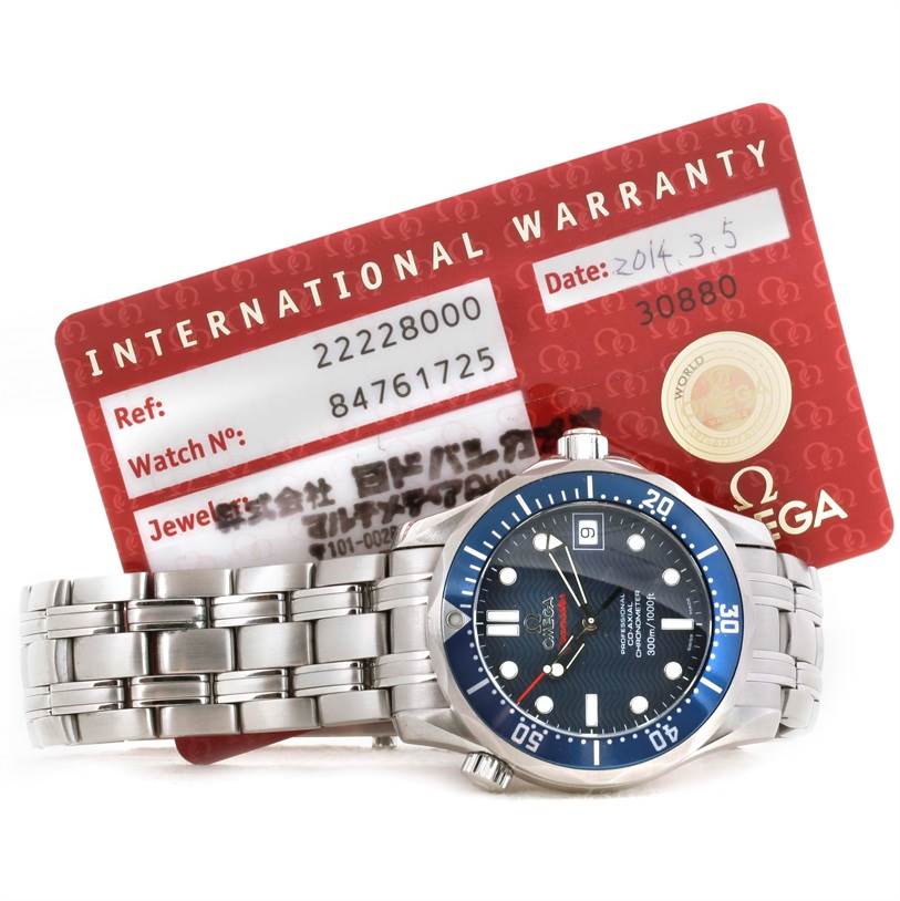 The Omega Seamaster 2222.80.00 Men
s Stainless Steel Blue Dial 2222.80.00 Men
s Stainless Steel Blue Dial watch is shown from a top-down angle with its bracelet band and international warranty card visible.