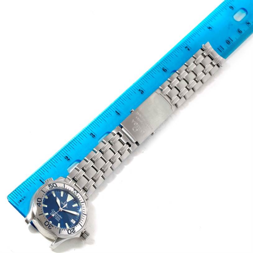 The image shows an Omega Seamaster 2053.80.00 Men
s Stainless Steel Blue Dial 2053.80.00 Men
s Stainless Steel Blue Dial watch laid flat next to a blue ruler, emphasizing the bracelet and clasp.