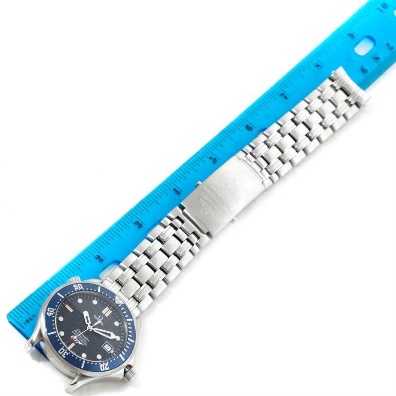 The Omega Seamaster 2537.80.00 Men
s Stainless Steel Blue Dial 2537.80.00 Men
s Stainless Steel Blue Dial watch is shown from an overhead angle, highlighting its face, bezel, and metal bracelet against a ruler for scale.