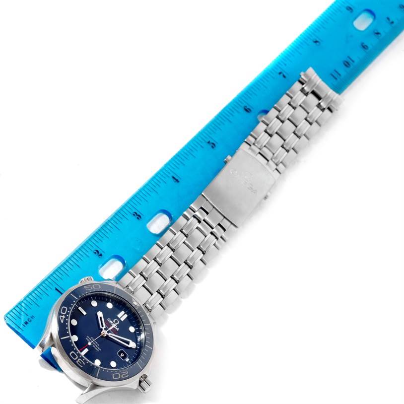 The Omega Seamaster 212.30.41.20.03.001 Men
s Stainless Steel Blue Dial 212.30.41.20.03.001 Men
s Stainless Steel Blue Dial watch is shown from a top-down angle with its face, bezel, and metal bracelet displayed next to a ruler.