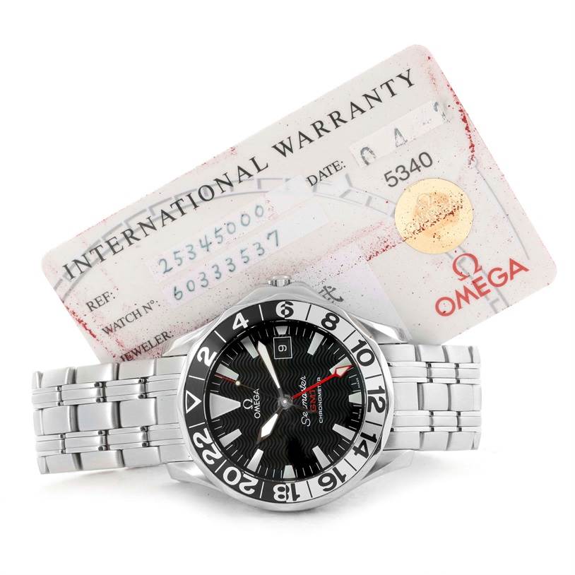 The image shows an Omega Seamaster 2534.50.00 Men's Stainless Steel Black Dial 2534.50.00 Men's Stainless Steel Black Dial watch with a stainless steel bracelet and an international warranty card behind it.