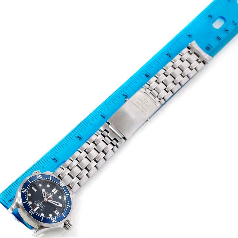 The image shows an Omega Seamaster 2222.80.00 Men
s Stainless Steel Blue Dial 2222.80.00 Men
s Stainless Steel Blue Dial watch lying flat with its full stainless steel bracelet extended beside a blue ruler.