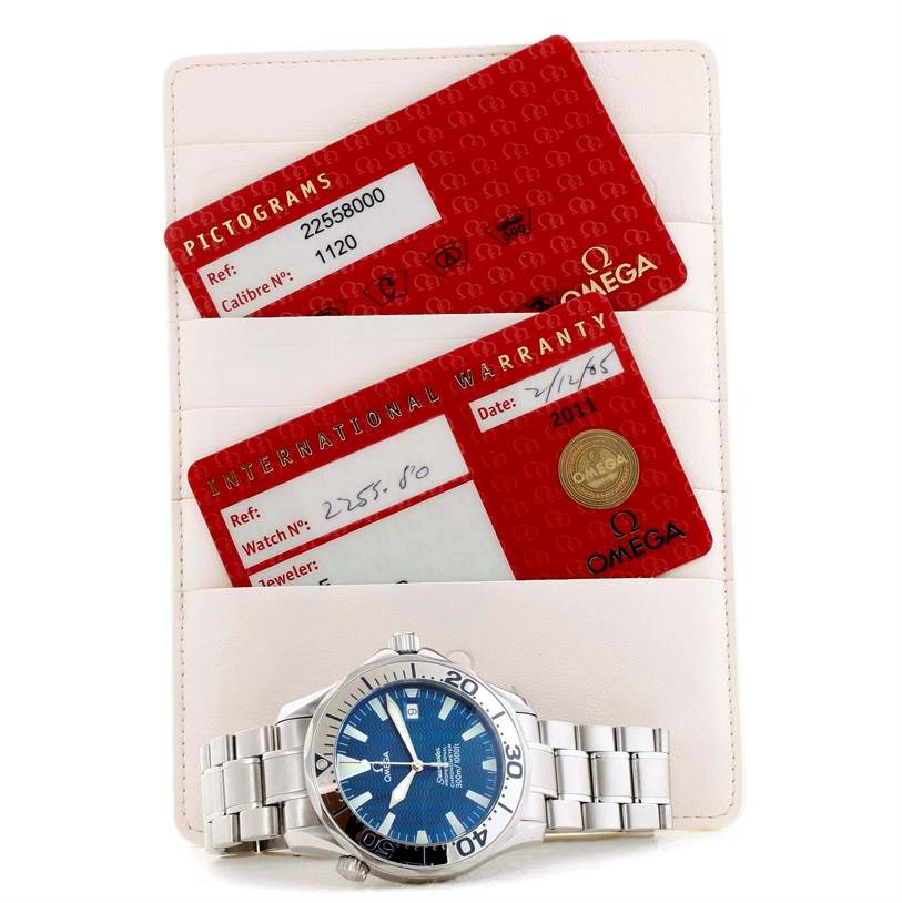The image shows an Omega Seamaster 2255.80.00 Men
s Stainless Steel Blue Dial 2255.80.00 Men
s Stainless Steel Blue Dial watch, its steel bracelet, and warranty cards displayed in a holder.
