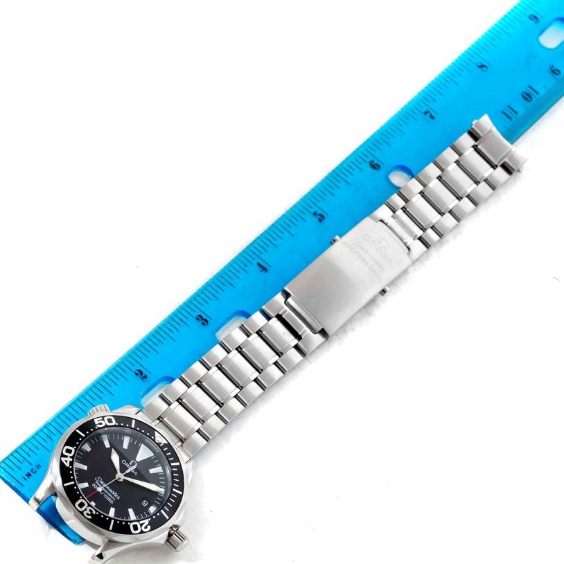 The Omega Seamaster 2262.50.00 Men
s Stainless Steel Black Dial 2262.50.00 Men
s Stainless Steel Black Dial watch is shown from a top-down angle, displaying its face, bracelet, and part of the clasp against a ruler.