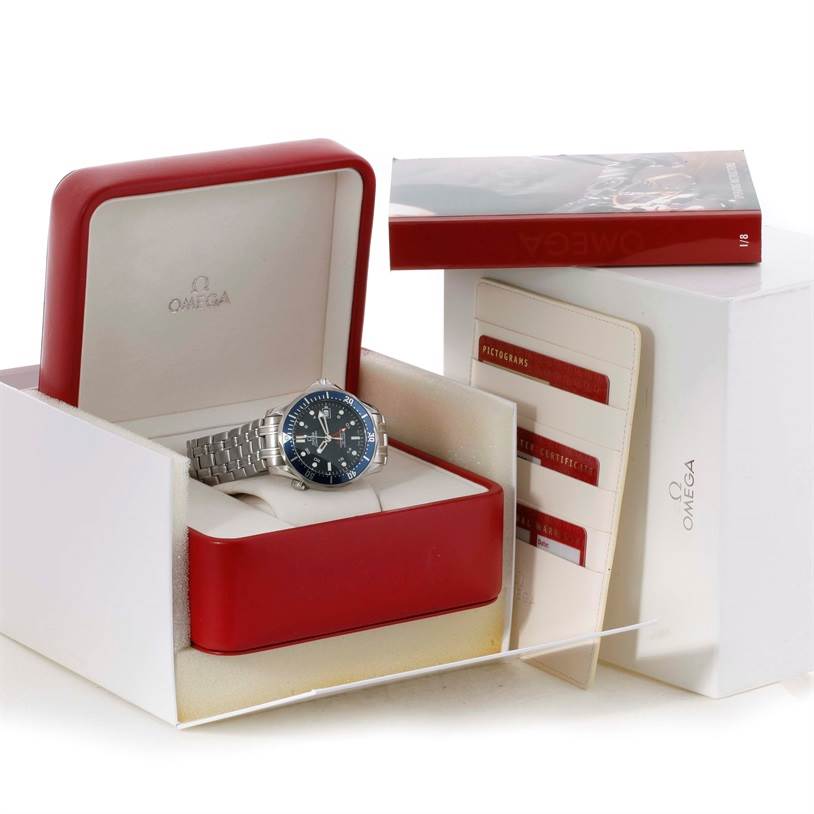 The Omega Seamaster 2535.80.00 Men
s Stainless Steel Blue Dial 2535.80.00 Men
s Stainless Steel Blue Dial watch is shown inside an open, red box with accompanying documentation and cards beside it.
