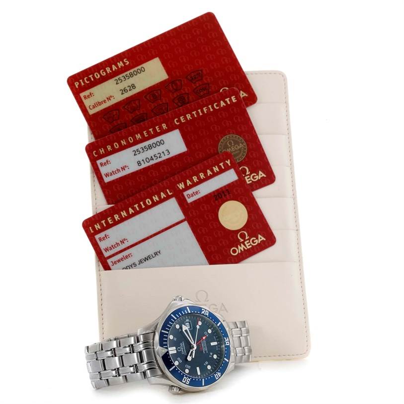 The image shows an Omega Seamaster 2535.80.00 Men
s Stainless Steel Blue Dial 2535.80.00 Men
s Stainless Steel Blue Dial watch with a metal band, alongside its warranty card, chronometer certificate, and pictogram card.