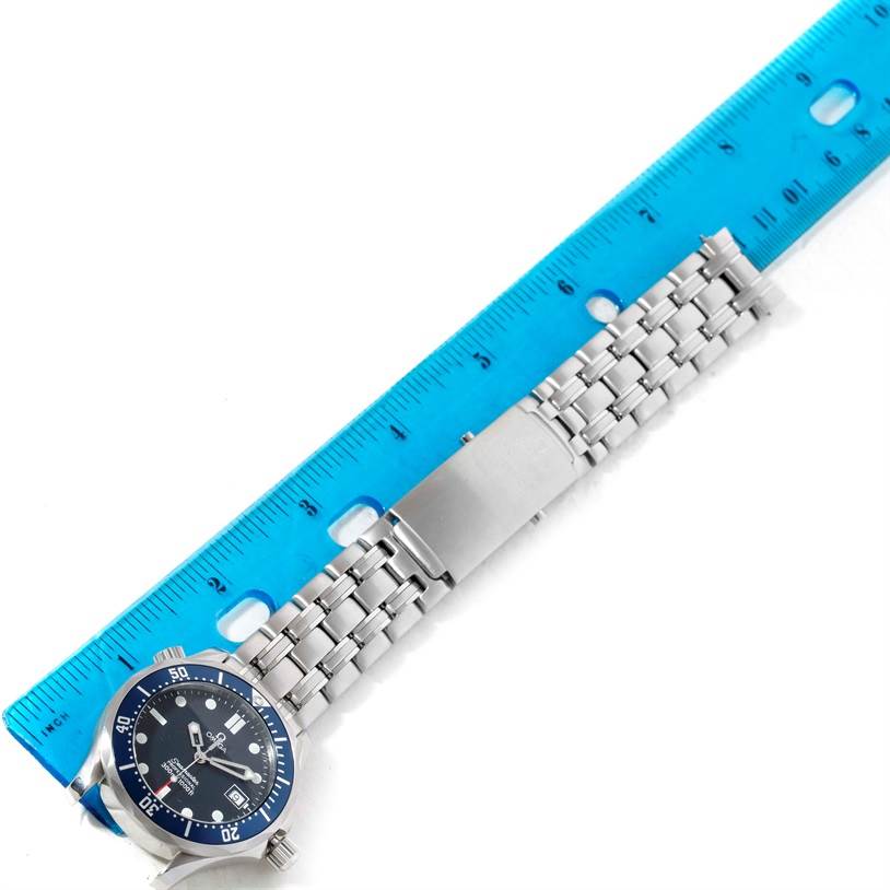 The image shows the Omega Seamaster 2561.80.00 Men
s Stainless Steel Blue Dial 2561.80.00 Men
s Stainless Steel Blue Dial watch and its metal bracelet laid flat beside a ruler.