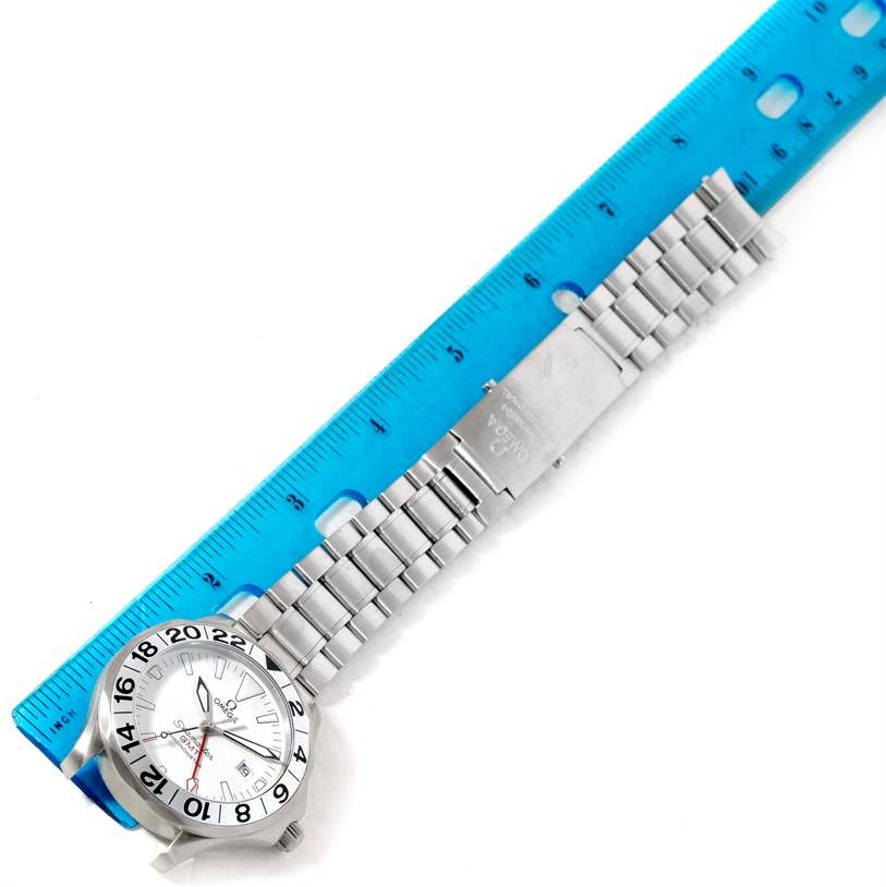 The image shows the Omega Seamaster 2538.20.00 Men's Stainless Steel White Dial 2538.20.00 Men's Stainless Steel White Dial watch laid flat with its stainless steel bracelet next to a ruler.