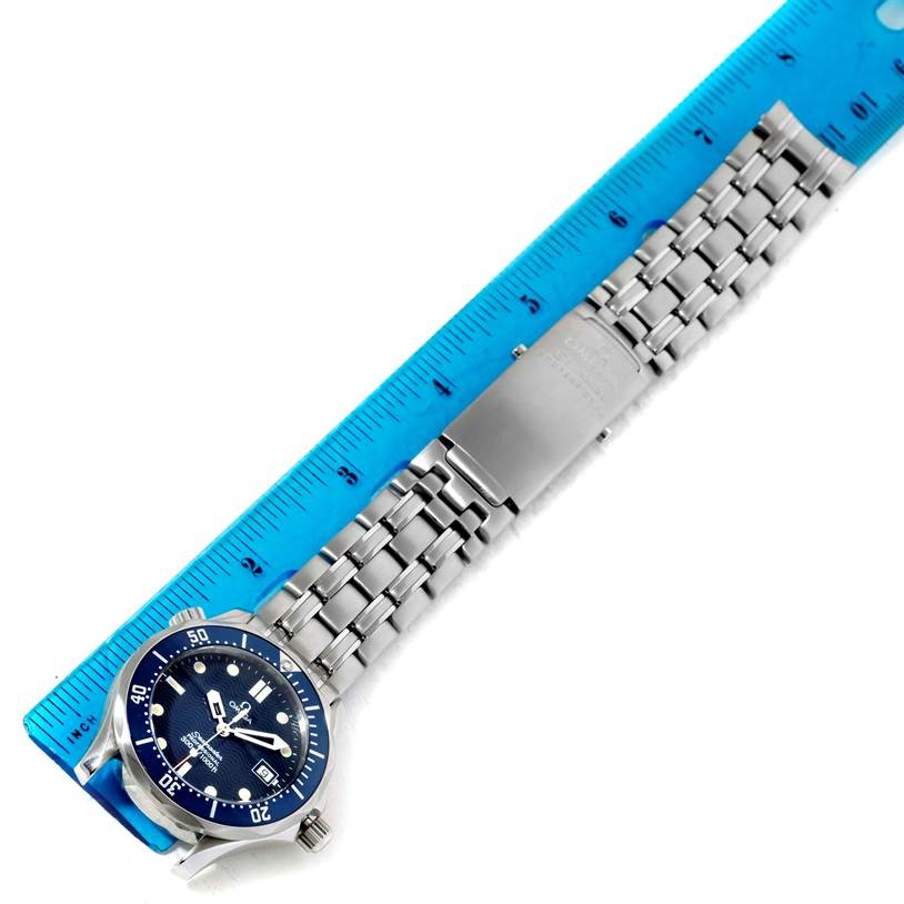 This image shows the Omega Seamaster 2561.80.00 Men
s Stainless Steel Blue Dial 2561.80.00 Men
s Stainless Steel Blue Dial watch lying flat with a blue ruler placed adjacent for size measurement.