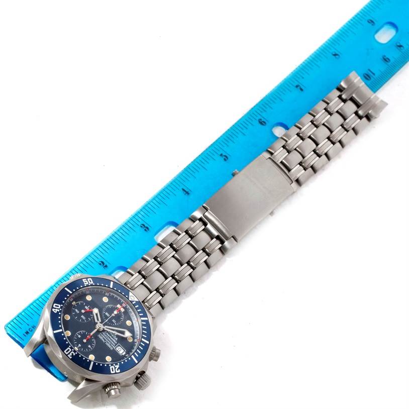 The image shows the Omega Seamaster 2298.80.00 Men's Titanium Blue Dial 2298.80.00 Men's Titanium Blue Dial watch lying flat with the face visible and a measuring ruler next to the metal bracelet.
