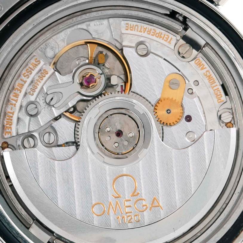 The image shows a close-up view of the movement inside an Omega Seamaster 2252.50.00 Men
s Stainless Steel Black Dial 2252.50.00 Men
s Stainless Steel Black Dial watch, highlighting its intricate mechanical parts.