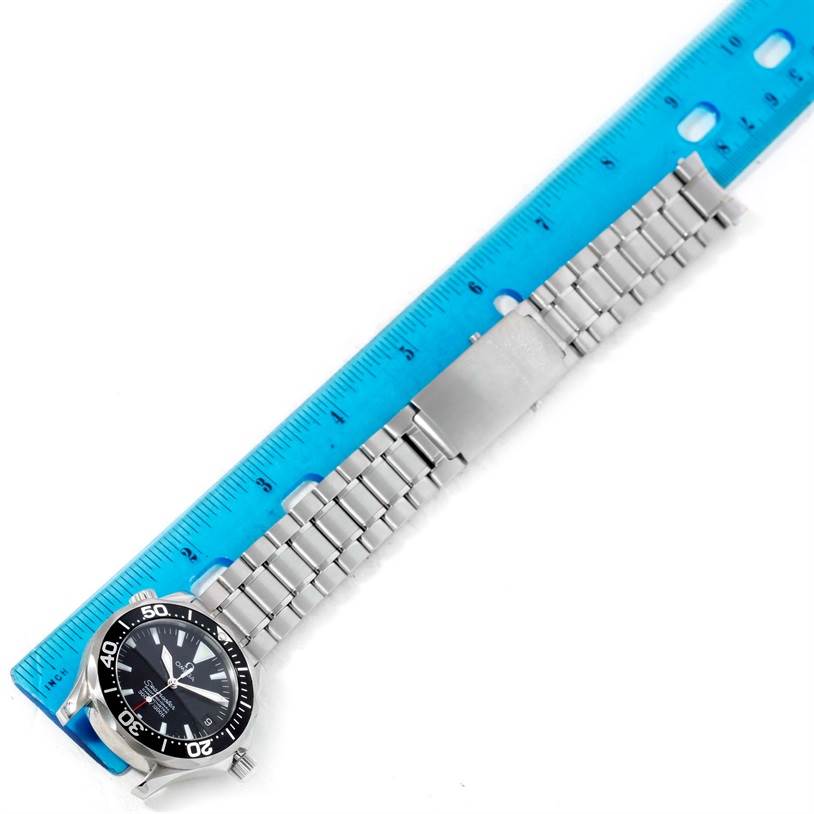 The Omega Seamaster 2252.50.00 Men
s Stainless Steel Black Dial 2252.50.00 Men
s Stainless Steel Black Dial watch shows the dial, bezel, stainless steel bracelet, and clasp, angled diagonally with a ruler for scale.