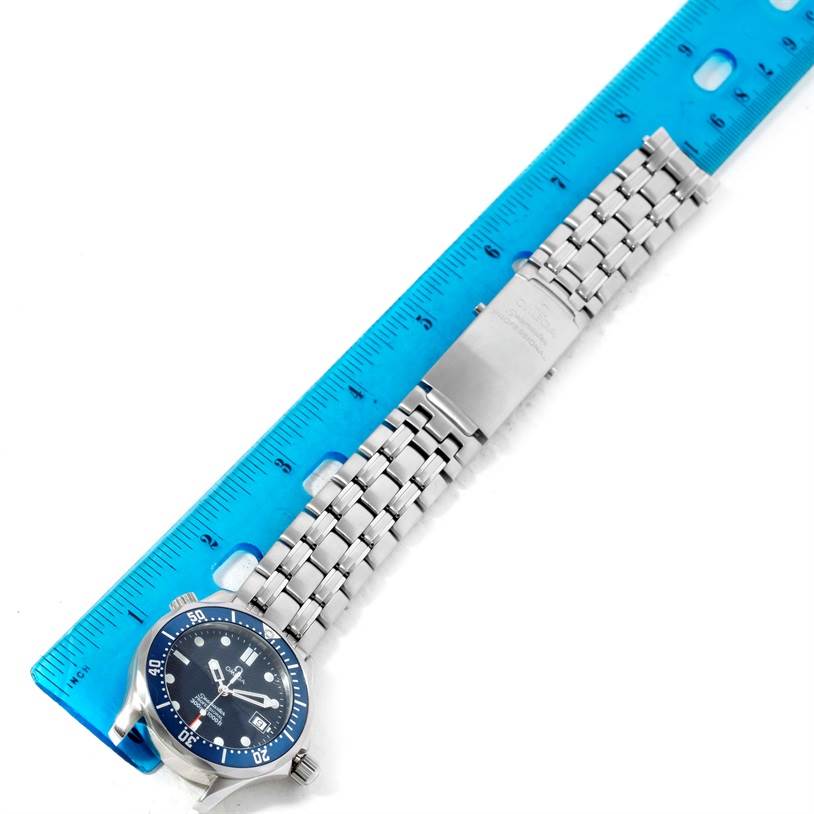 The image shows the Omega Seamaster 2561.80.00 Men
s Stainless Steel Blue Dial 2561.80.00 Men
s Stainless Steel Blue Dial watch flat, with its face, bracelet, and clasp next to a blue ruler for size reference.