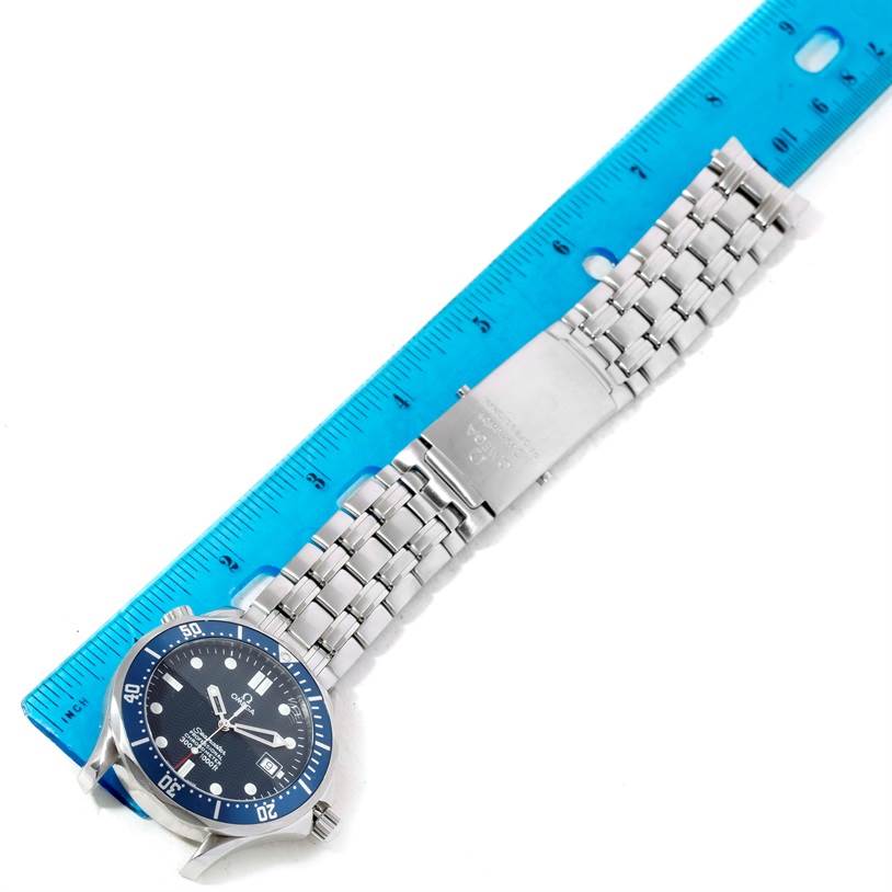 The image shows the front view of an Omega Seamaster 2531.80.00 Men
s Stainless Steel Blue Dial 2531.80.00 Men
s Stainless Steel Blue Dial watch with a blue dial, silver bracelet, and a blue ruler for scale.