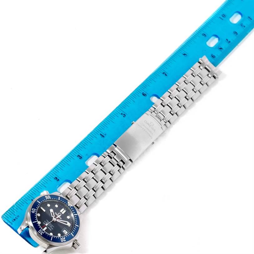 The image shows an Omega Seamaster 2222.80.00 Men
s Stainless Steel Blue Dial 2222.80.00 Men
s Stainless Steel Blue Dial watch laid flat against a ruler, highlighting the dial, bezel, and stainless steel bracelet.