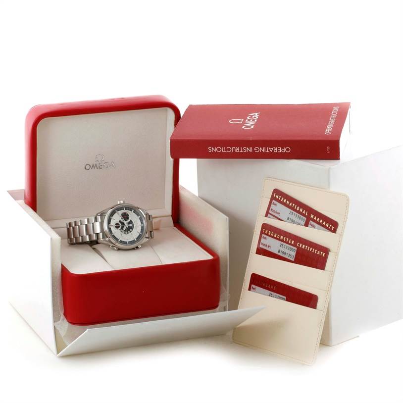 The image shows an Omega Seamaster 2513.30.00 Men
s Stainless Steel Silver Dial 2513.30.00 Men
s Stainless Steel Silver Dial watch at an angle, inside its box, alongside warranty cards and an operating instructions booklet.