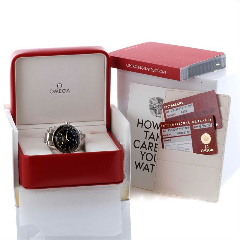 The image shows an Omega Seamaster 233.30.41.21.01.001 Men
s Stainless Steel Black Dial 233.30.41.21.01.001 Men
s Stainless Steel Black Dial watch in its box, along with accompanying documentation, including warranty cards and an instruction book.