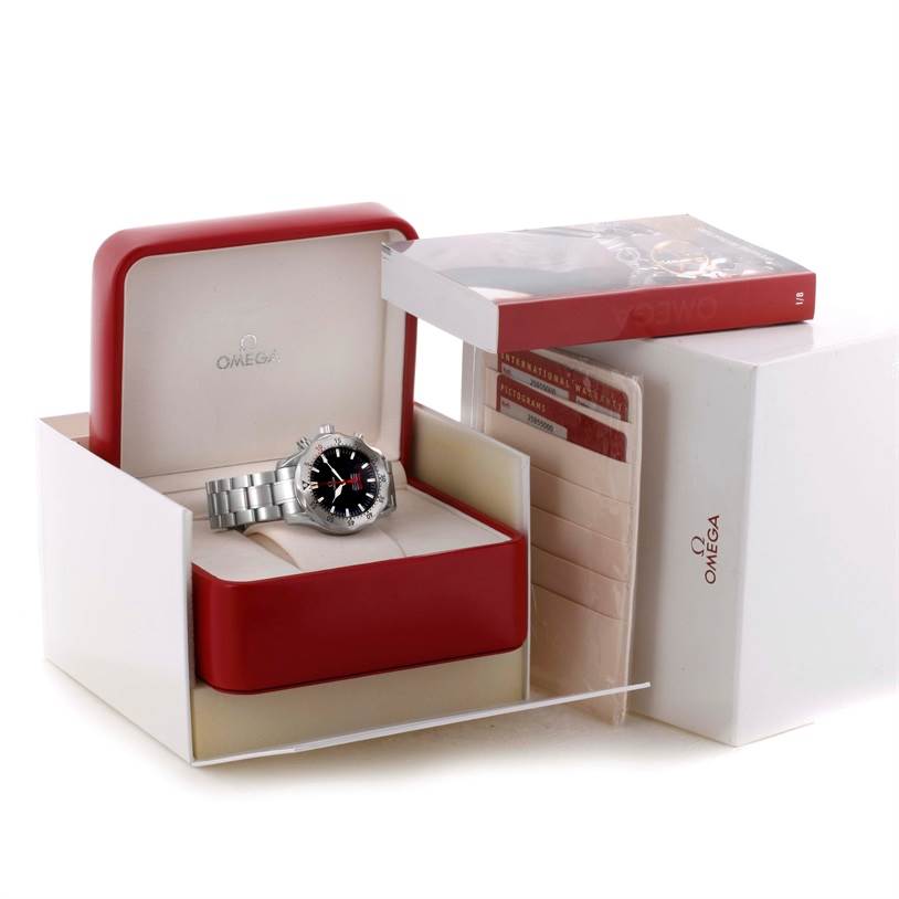 The image shows an Omega Seamaster 2595.50.00 Men
s Stainless Steel Black Dial 2595.50.00 Men
s Stainless Steel Black Dial watch in its open box with accompanying warranty cards and packaging.