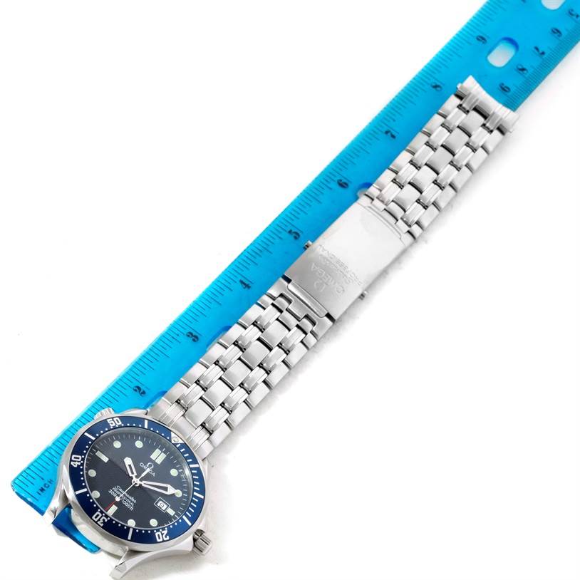 The Omega Seamaster 2541.80.00 Men
s Stainless Steel Blue Dial 2541.80.00 Men
s Stainless Steel Blue Dial watch is shown laying flat with its blue face, bezel, and metal bracelet fully visible next to a ruler.