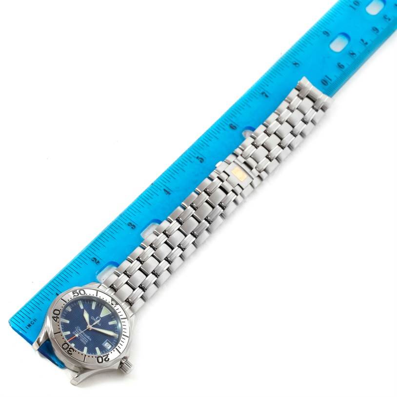 The image shows the full bracelet and face of the Omega Seamaster 2554.80.00 Men
s Stainless Steel Blue Dial 2554.80.00 Men
s Stainless Steel Blue Dial watch, next to a blue ruler for scale.