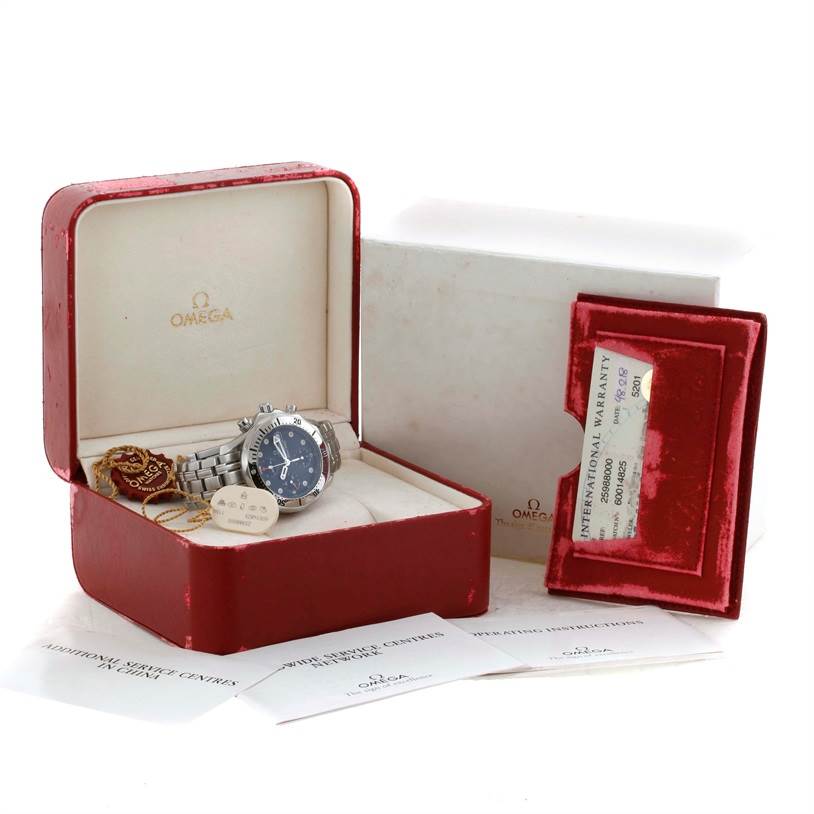 The Omega Seamaster 2598.80.00 Men
s Stainless Steel Blue Dial 2598.80.00 Men
s Stainless Steel Blue Dial watch is displayed in its open red box, accompanied by tags, guarantee card, and paperwork.