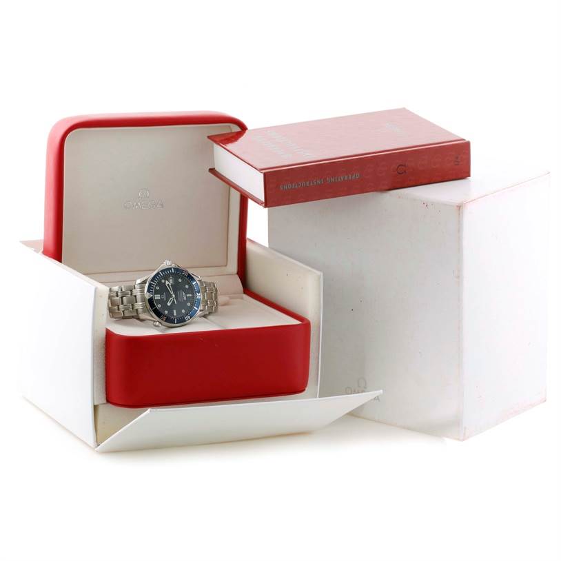 The Omega Seamaster 2537.80.00 Men
s Stainless Steel Blue Dial 2537.80.00 Men
s Stainless Steel Blue Dial watch is shown at a front angle inside an open red and white display box, accompanied by an instruction manual.
