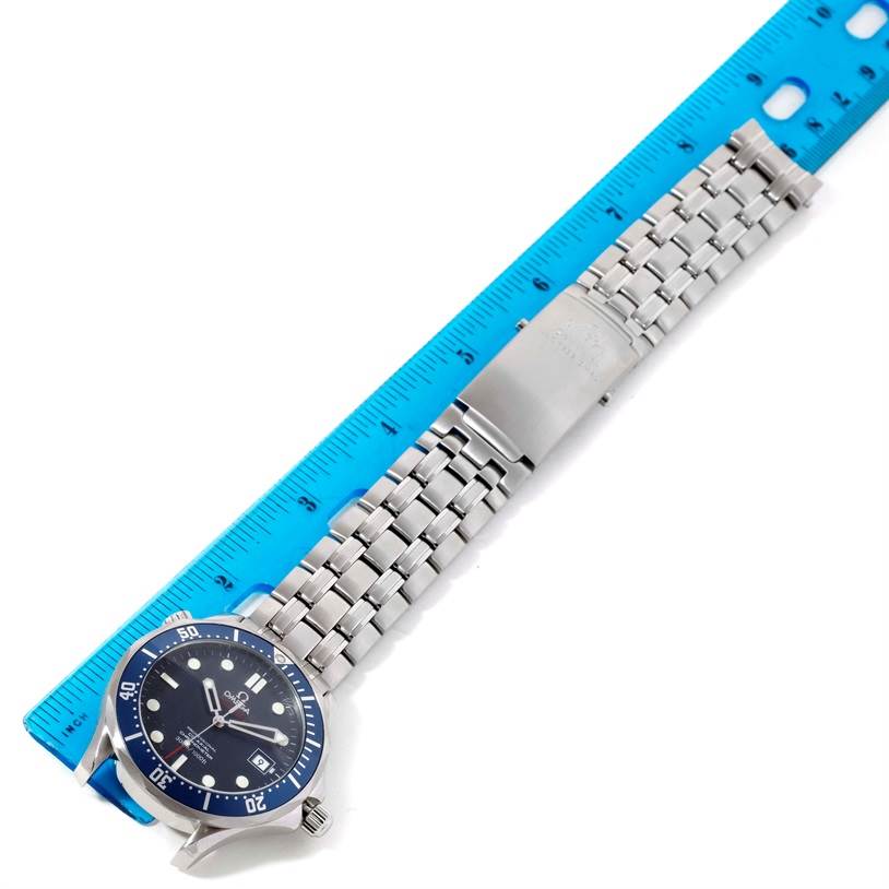 The image shows an Omega Seamaster 2220.80.00 Men
s Stainless Steel Blue Dial 2220.80.00 Men
s Stainless Steel Blue Dial watch laid flat next to a ruler, displaying the watch face and metal strap.