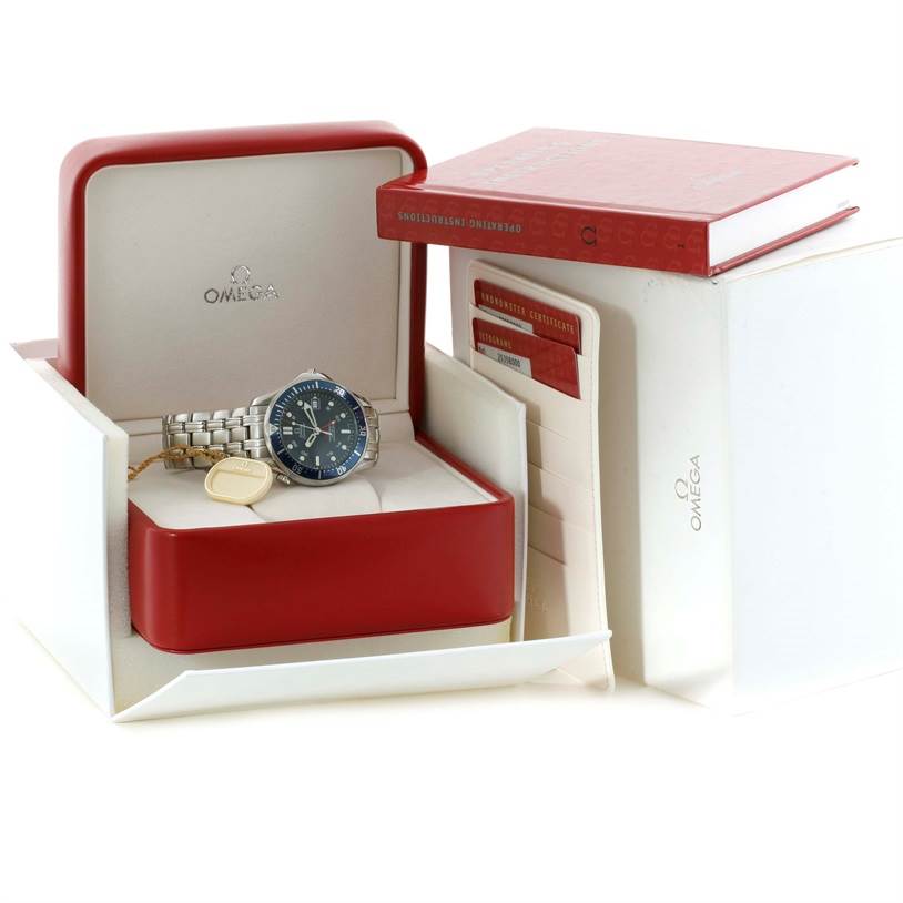 An Omega Seamaster 2535.80.00 Men
s Stainless Steel Blue Dial 2535.80.00 Men
s Stainless Steel Blue Dial watch is displayed in an open red box, alongside warranty cards and an instruction manual.
