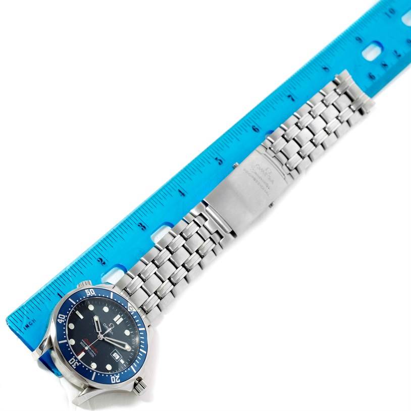 The image shows the Omega Seamaster 2221.80.00 Men
s Stainless Steel Blue Dial 2221.80.00 Men
s Stainless Steel Blue Dial watch laid flat next to a blue ruler, highlighting the face, bracelet, and clasp.