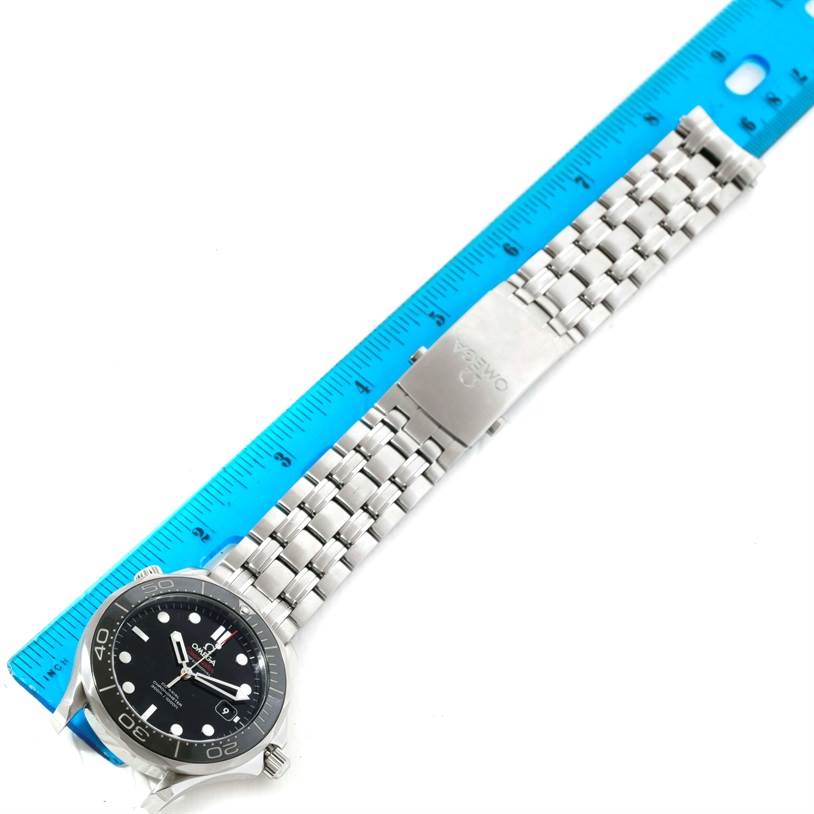 The image shows an Omega Seamaster 212.30.41.20.01.002 Men
s Stainless Steel Black Dial 212.30.41.20.01.002 Men
s Stainless Steel Black Dial watch laid flat with a blue ruler next to it, displaying the face and metal bracelet.