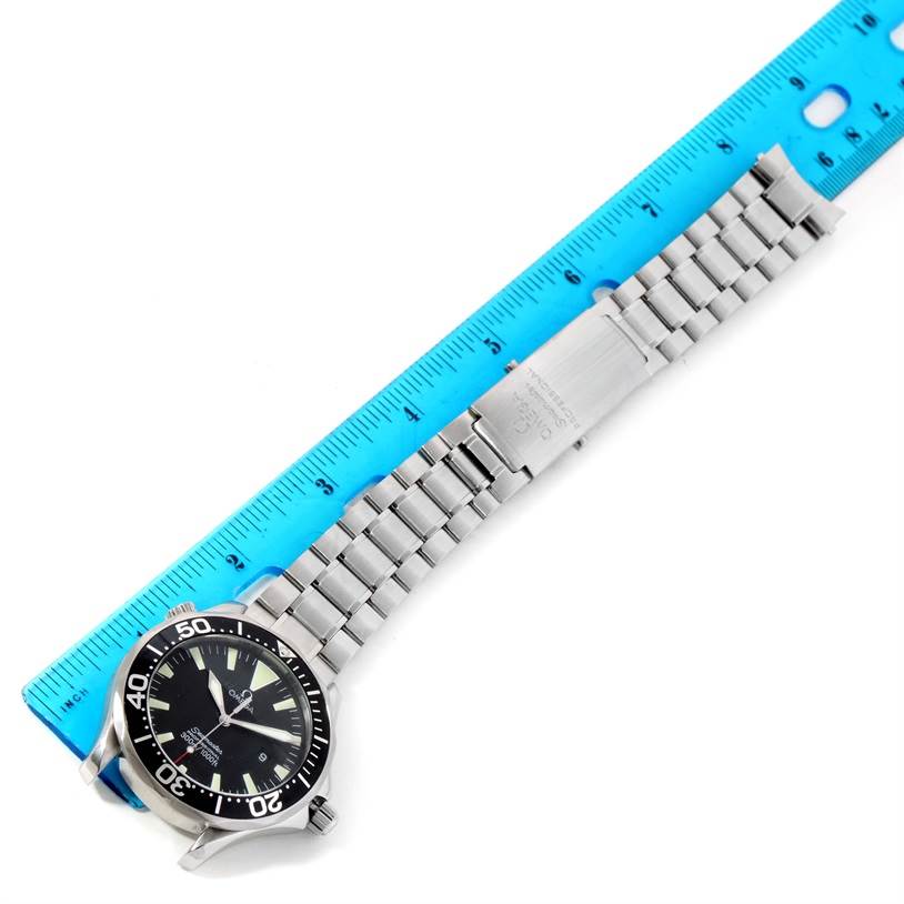 The Omega Seamaster 2264.50.00 Men
s Stainless Steel Black Dial 2264.50.00 Men
s Stainless Steel Black Dial watch is shown at a slight angle, displaying its face, bezel, and metal bracelet against a ruler.