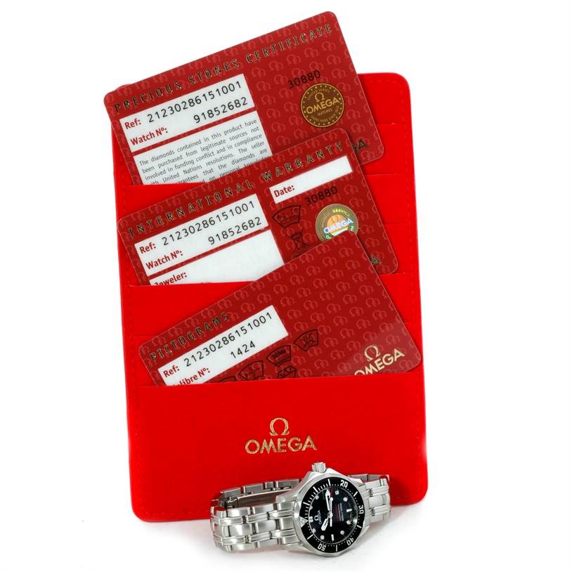 The image shows an Omega Seamaster 212.30.28.61.01.001 Women's Stainless Steel Black Dial 212.30.28.61.01.001 Women's Stainless Steel Black Dial watch with its bracelet and warranty cards angled above a red Omega cardholder.