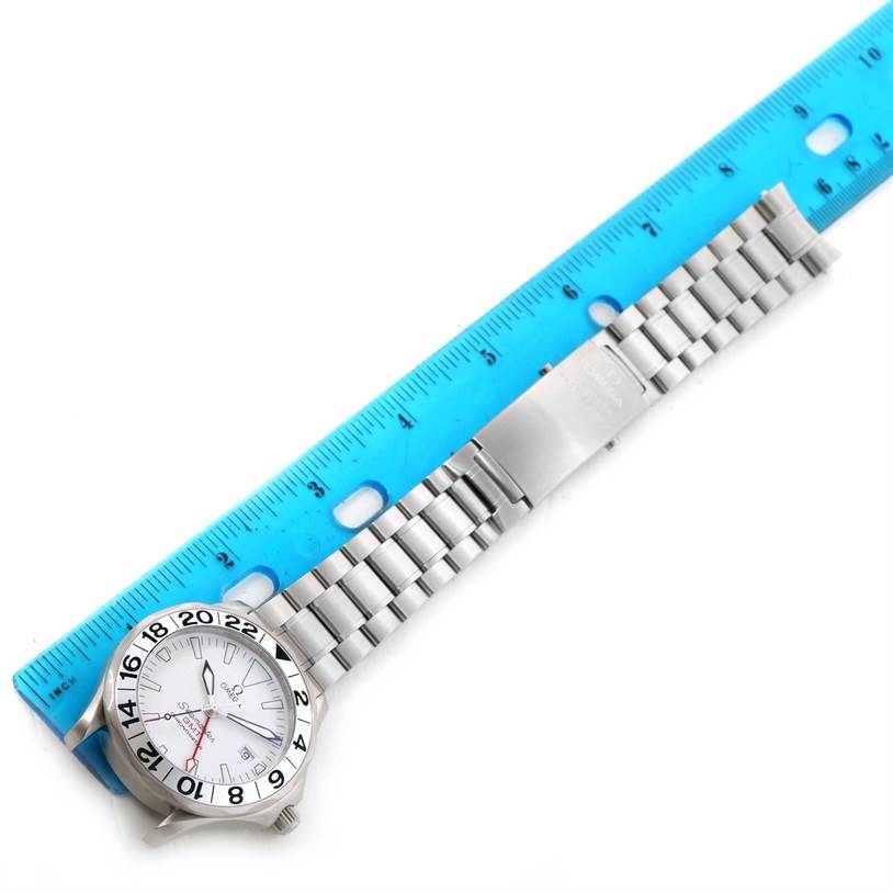 The Omega Seamaster 2538.20.00 Men
s Stainless Steel White Dial 2538.20.00 Men
s Stainless Steel White Dial watch is shown horizontally with its face and entire metal bracelet visible, placed next to a blue ruler.