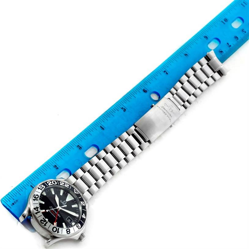 The Omega Seamaster 2534.50.00 Men
s Stainless Steel Black Dial 2534.50.00 Men
s Stainless Steel Black Dial watch is shown flat, with the face and stainless steel bracelet visible alongside a blue ruler.