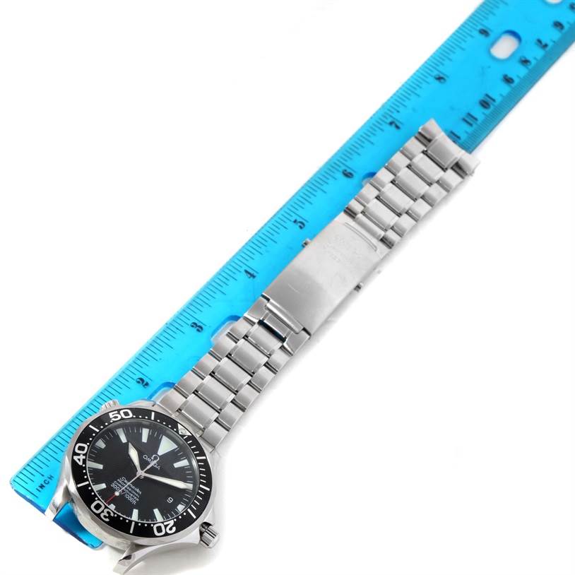 The image shows an Omega Seamaster 2254.50.00 Men
s Stainless Steel Black Dial 2254.50.00 Men
s Stainless Steel Black Dial watch laid out flat next to a ruler, displaying the dial and metal bracelet.