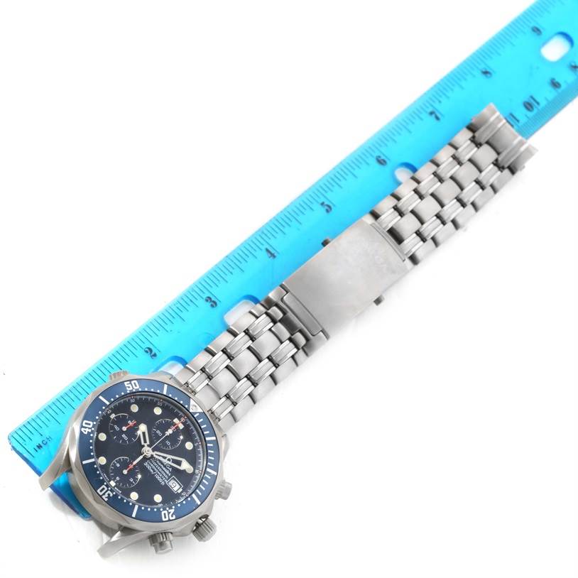 The Omega Seamaster 2298.80.00 Men
s Titanium Blue Dial 2298.80.00 Men
s Titanium Blue Dial watch is shown from an angled top view, displaying the watch face and the metal bracelet alongside a ruler.