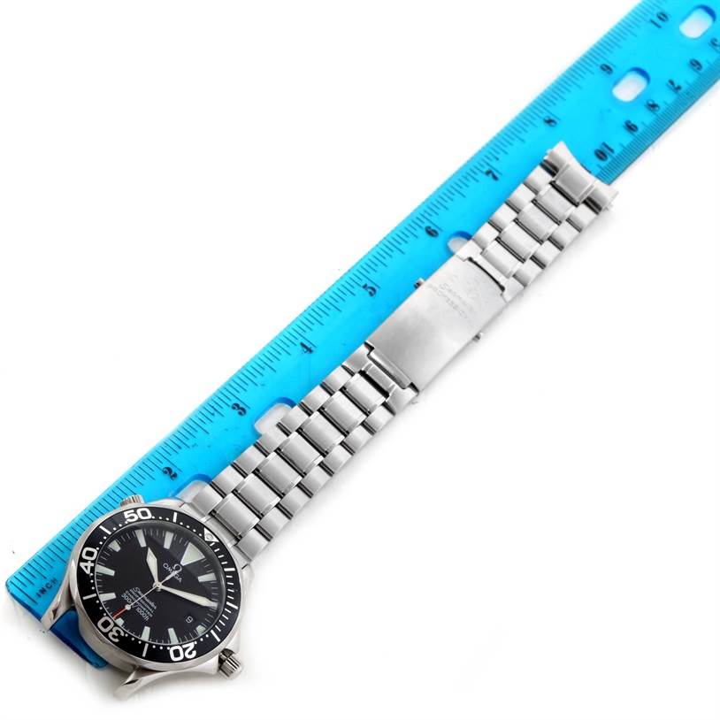 The image shows an Omega Seamaster 2254.50.00 Men
s Stainless Steel Black Dial 2254.50.00 Men
s Stainless Steel Black Dial watch laid flat, with a blue ruler measuring its length, displaying the watch face and metal bracelet.