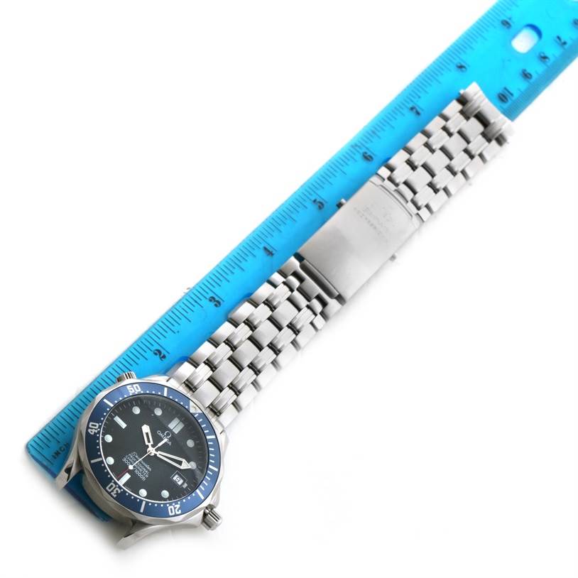 The image shows an Omega Seamaster 2531.80.00 Men
s Stainless Steel Blue Dial 2531.80.00 Men
s Stainless Steel Blue Dial watch laid flat next to a blue ruler, displaying the face, bezel, crown, and metal bracelet.