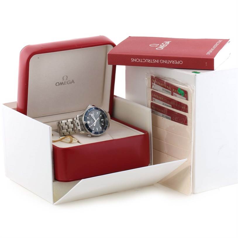 The image shows an Omega Seamaster 2535.80.00 Men
s Stainless Steel Blue Dial 2535.80.00 Men
s Stainless Steel Blue Dial watch in its box, accompanied by an operating manual and warranty cards.