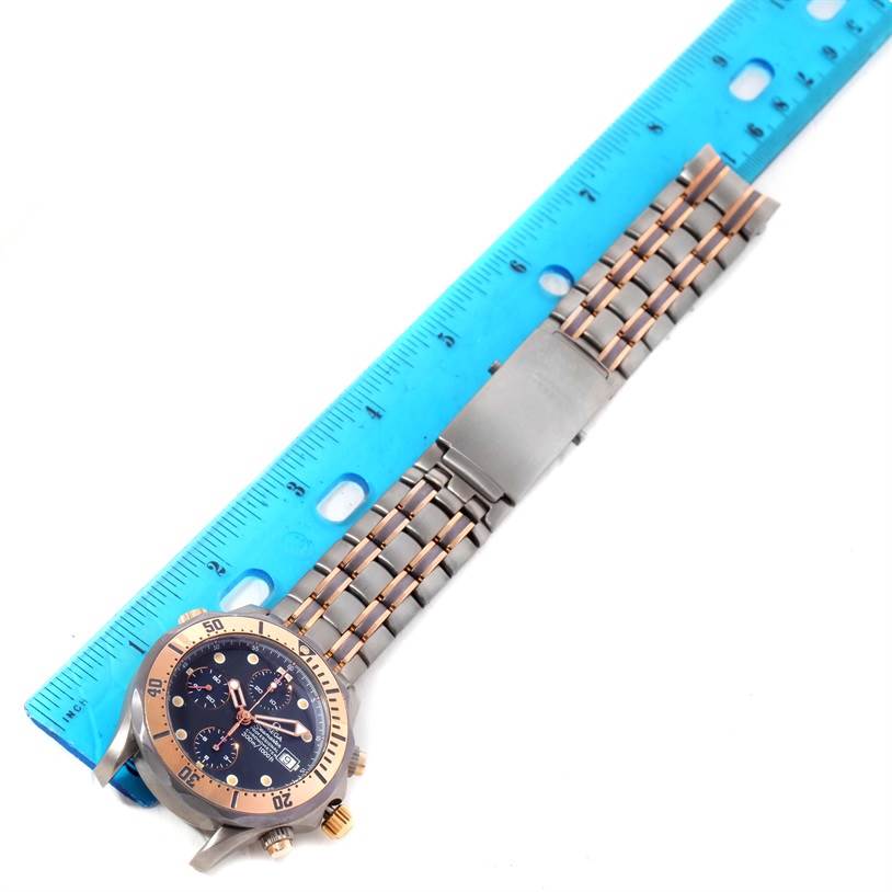 The Omega Seamaster 2296.80.00 Men's Titanium Blue Dial 2296.80.00 Men's Titanium Blue Dial watch is shown from a top-down view, with a ruler placed next to its metal bracelet.